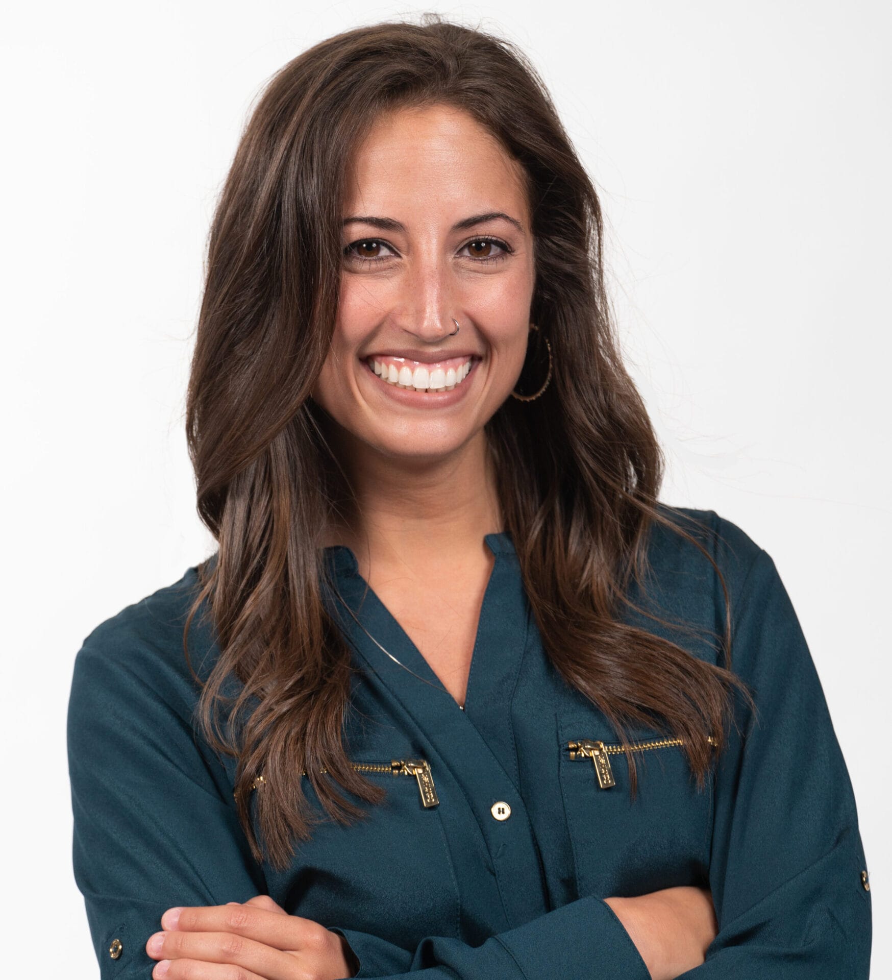 Headshot of Dr. Dorfner in a dark teal long-sleeve blouse with gold zipper details on the chest pockets