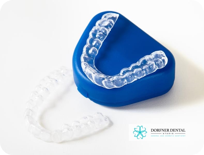 Close-up image of a set of Invisalign aligners neatly arranged on a dental tray, showcasing the transparent design and precision fit.