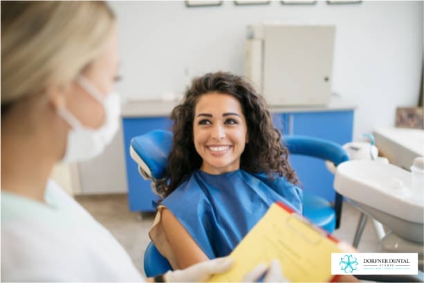Woman sitting in dental chair smiling