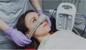 Patient receiving sedation dentistry with a nasal mask at Dorfner Dental Studio
